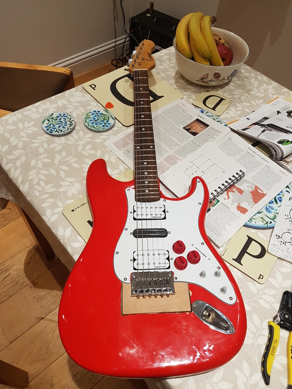 A completed guitar. It has three controls, and three missing.